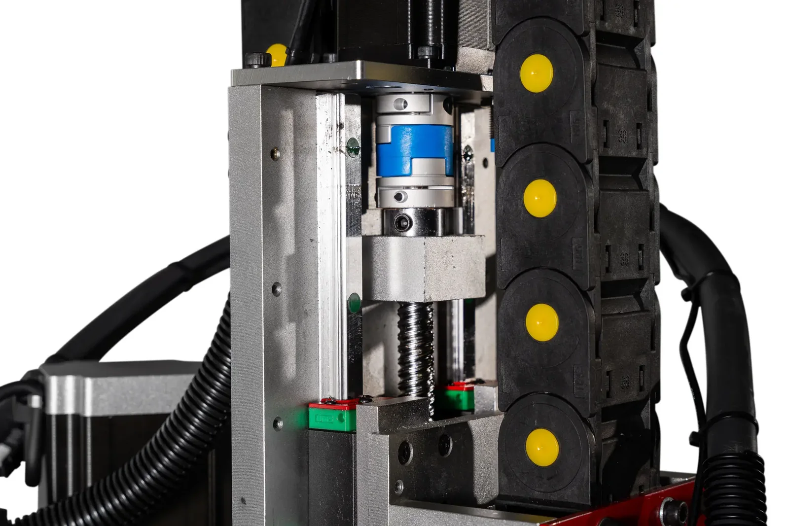 Close-up of the Arclight Z axis with a ball screw, coupler, and yellow drag chain