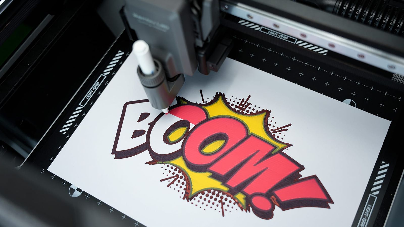 The H2D pen attachment drawing a multicolor design inside the machine