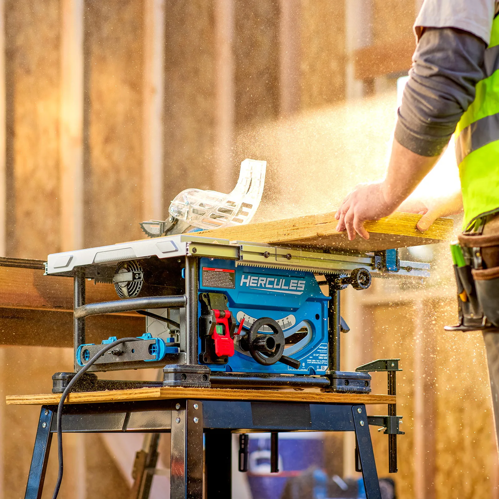A woodworker feeding a board across the HERCULES saw on a stand