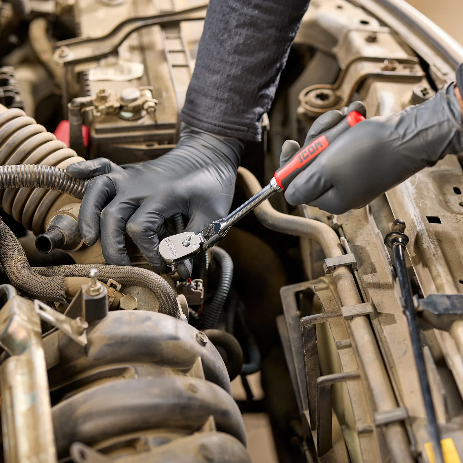 An ICON G2 comfort-grip ratchet working on an engine