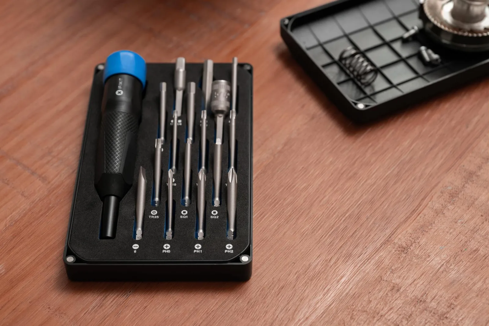 The Megalodon driver and bits laid out in their black case on a wooden desk
