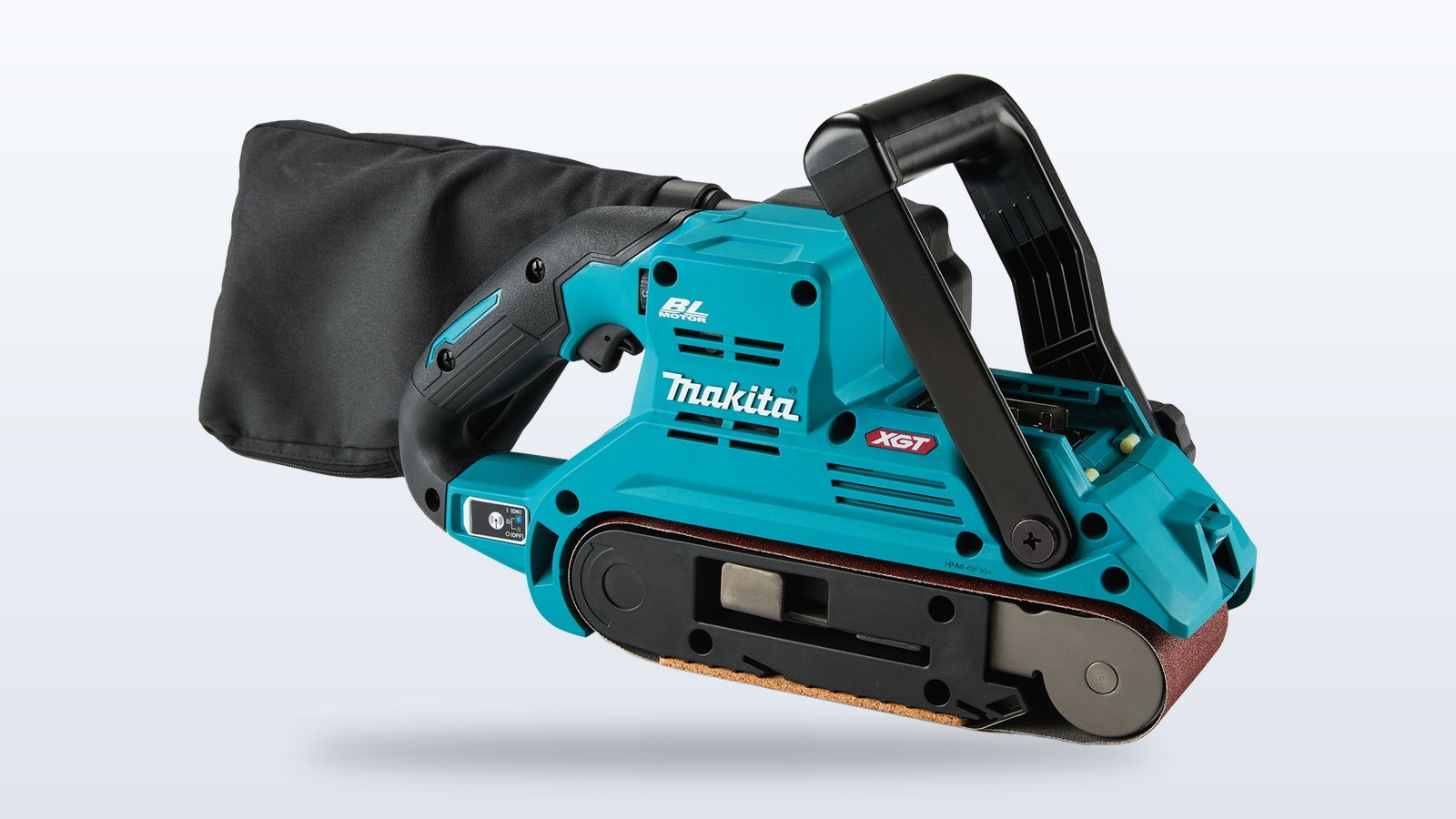 Makita 40V max XGT cordless belt sander with its black dust bag and large front handle