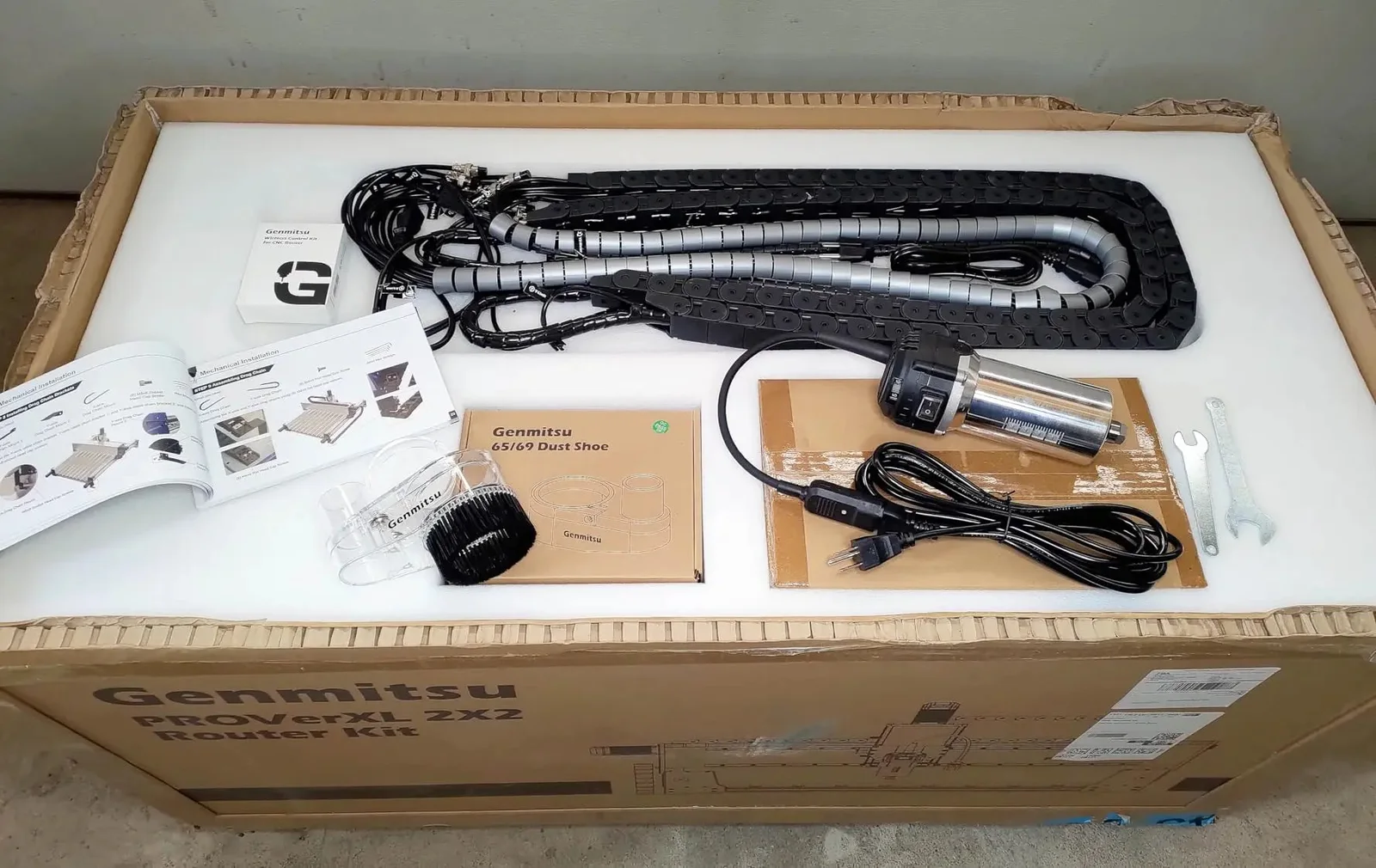 The PROVerXL 2×2 kit contents laid out in the box, including drag chain, spindle, dust shoe, and manual