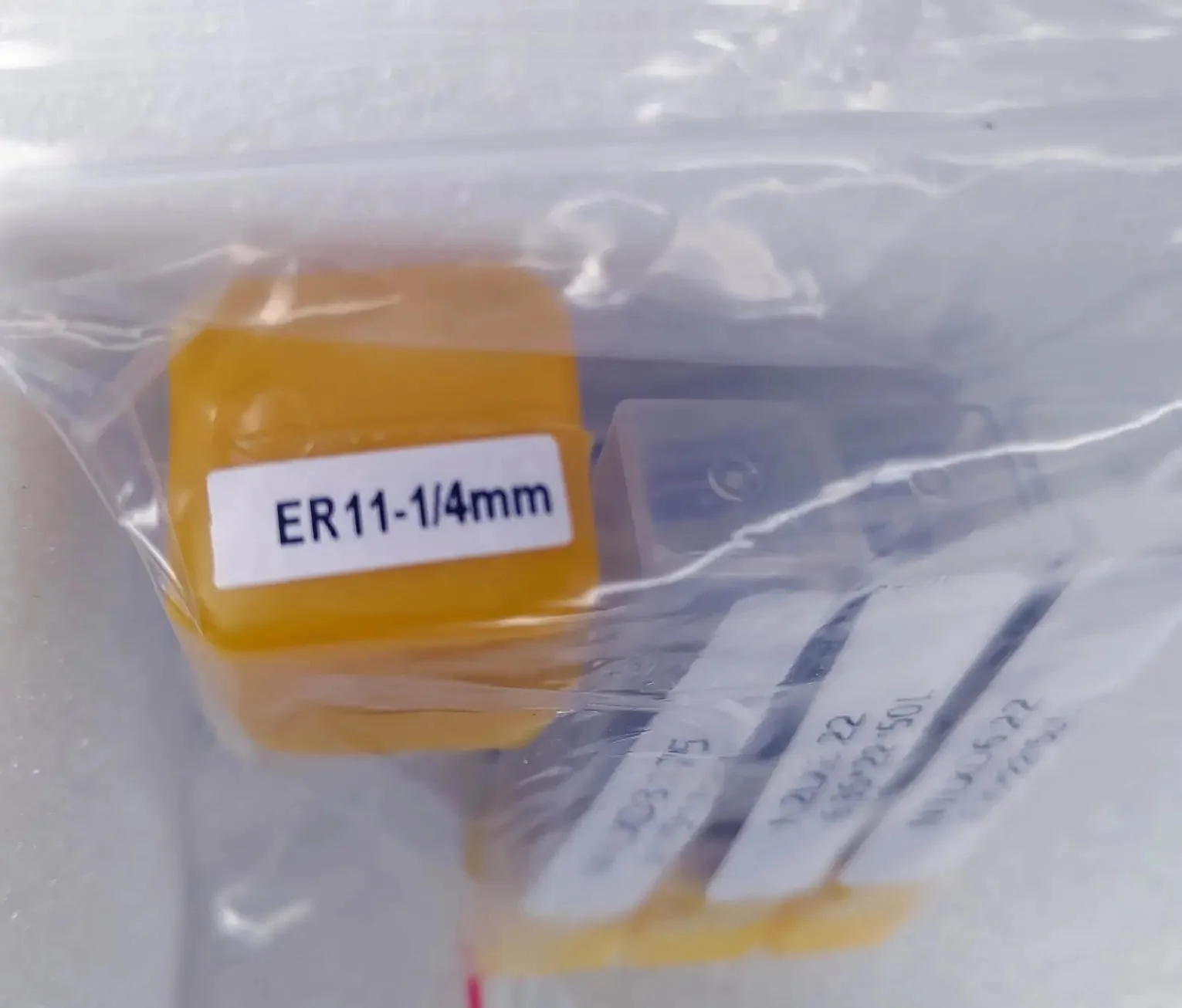A bag of ER11 collets labeled 1/4 inch from the accessory kit
