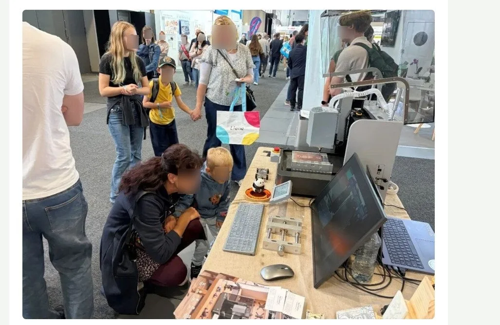 A crowd at the TwoTrees booth examining the ED1 on a display table