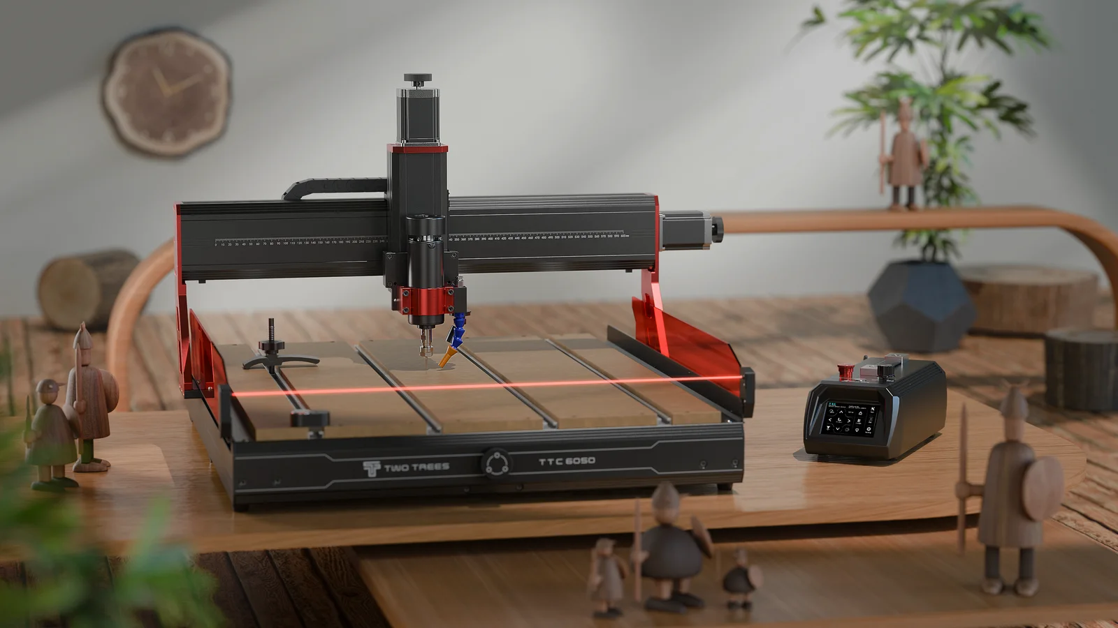 A TwoTrees router sitting on a bench, with small carved wooden figures behind it