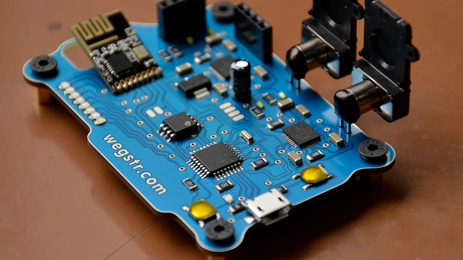 A small circuit board with a WEGSTR name, a USB port, and soldered parts