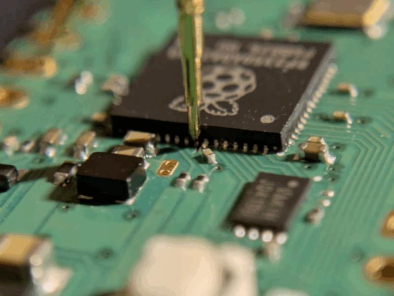 Close-up of an RP2350 chip prepared for hardware security testing