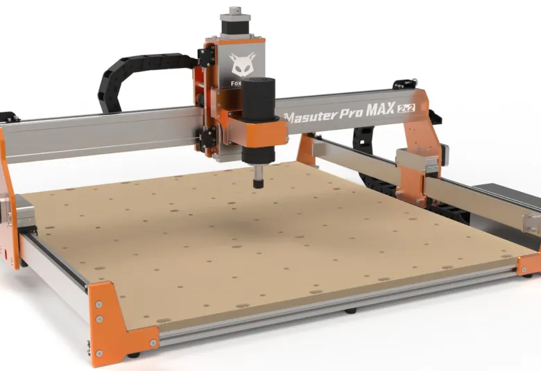 FoxAlien Masuter Pro Max 2×2 CNC router rendered on a white background, with orange end plates, a silver gantry, and a brushless spindle above a perforated MDF bed