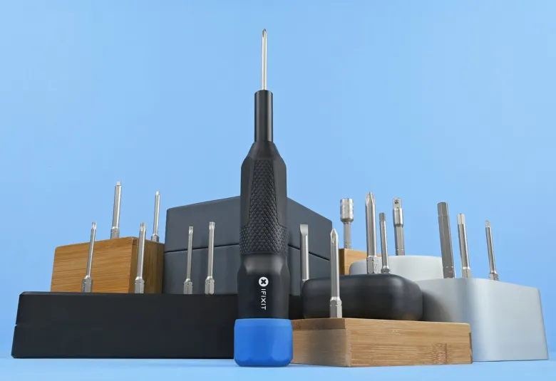iFixit Megalodon driver with a blue cap standing among bit holders against a blue background