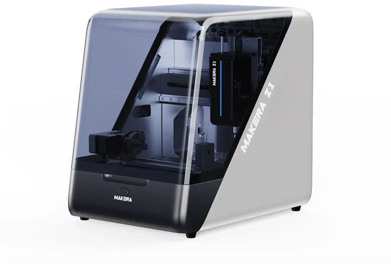 Makera Z1 desktop CNC machine with a dark tinted enclosure and a white and silver side panel carrying the Makera Z1 name, shown at a three-quarter angle on a white background