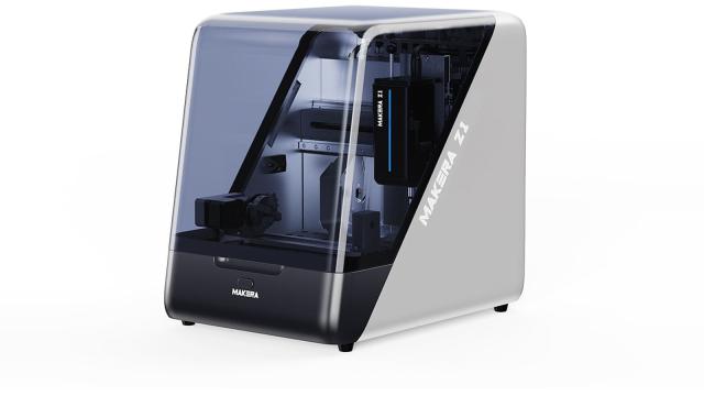 Makera Z1 desktop CNC machine with a dark tinted enclosure and a white and silver side panel carrying the Makera Z1 name, shown at a three-quarter angle on a white background