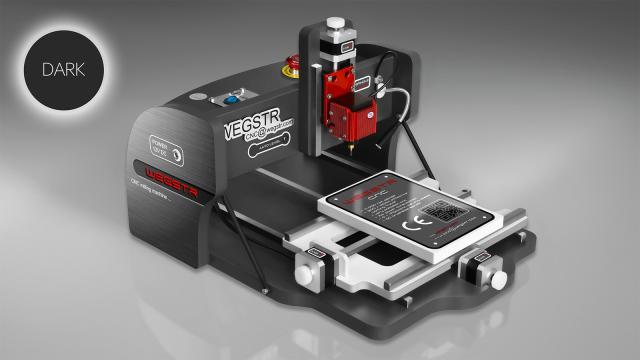 CNC Wegstr DARK desktop CNC mill in dark gray with a red spindle head and a small work plate on its sliding table