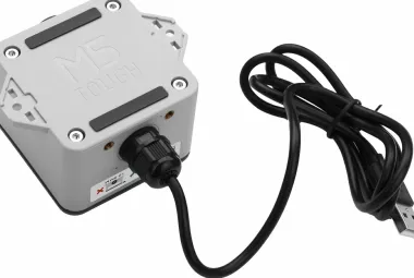M5Stack ToughC5 controller in its gray enclosure with a cable attached