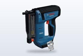 Bosch 18V cordless 23-gauge pin nailer resting against a piece of trim