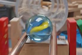 A still from Google's Omni launch showing a marble on a shop-style track