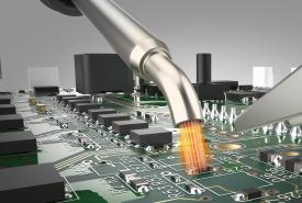 Hot air from a Hakko FR-850 nozzle heating a surface-mount part on a crowded circuit board