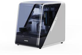 Makera Z1 desktop CNC machine with a dark tinted enclosure and a white and silver side panel carrying the Makera Z1 name, shown at a three-quarter angle on a white background
