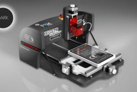 CNC Wegstr DARK desktop CNC mill in dark gray with a red spindle head and a small work plate on its sliding table