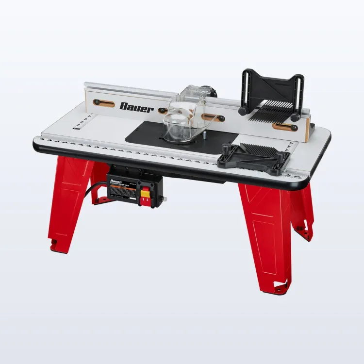 Red-legged BAUER benchtop router table with a router mounted underneath and a clear bit guard