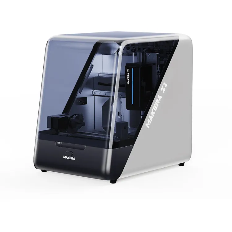 Makera Z1 desktop CNC machine with a dark tinted enclosure and a white and silver side panel carrying the Makera Z1 name, shown at a three-quarter angle on a white background