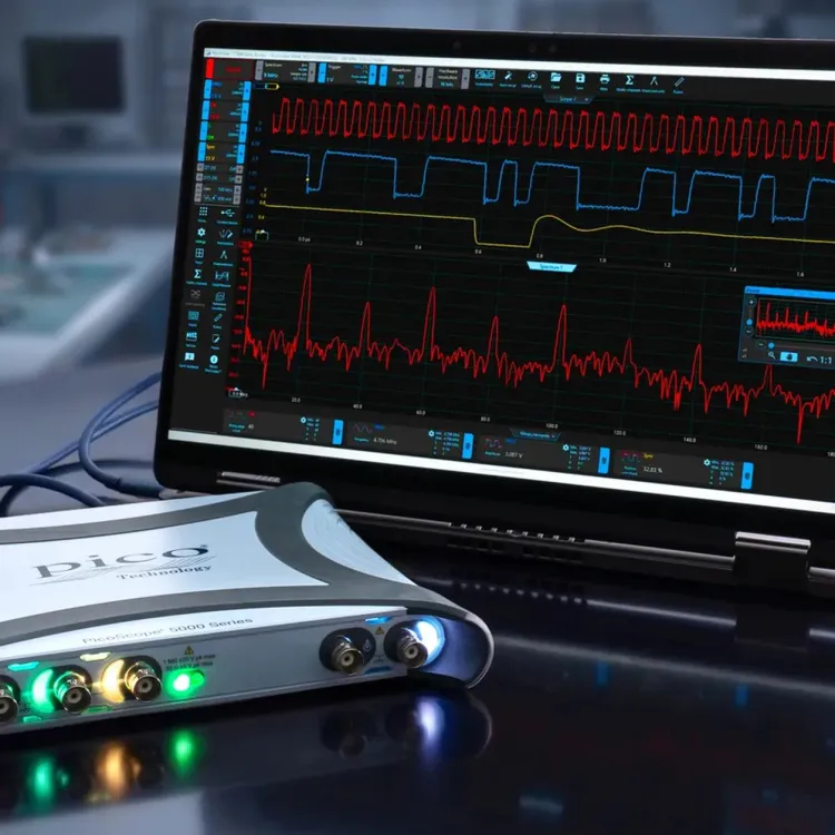 PicoScope 5000E USB oscilloscope with colored channel lights beside a laptop running PicoScope 7