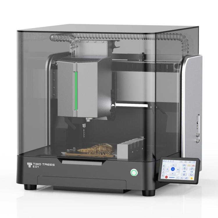 TwoTrees ED1 enclosed desktop CNC machine with a smoked glass cover, spindle and tool changer inside, a carved piece on the bed, and a touchscreen at the front right