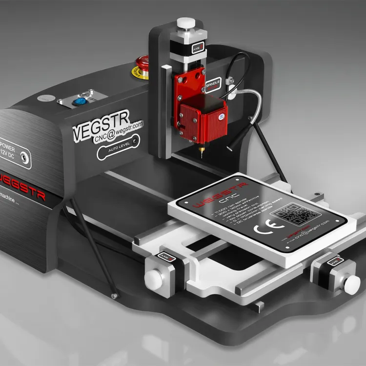 CNC Wegstr DARK desktop CNC mill in dark gray with a red spindle head and a small work plate on its sliding table