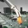 Hot air from a Hakko FR-850 nozzle heating a surface-mount part on a crowded circuit board
